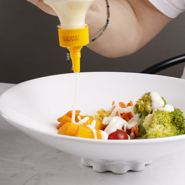 A white ceramic deep dish with salad on it